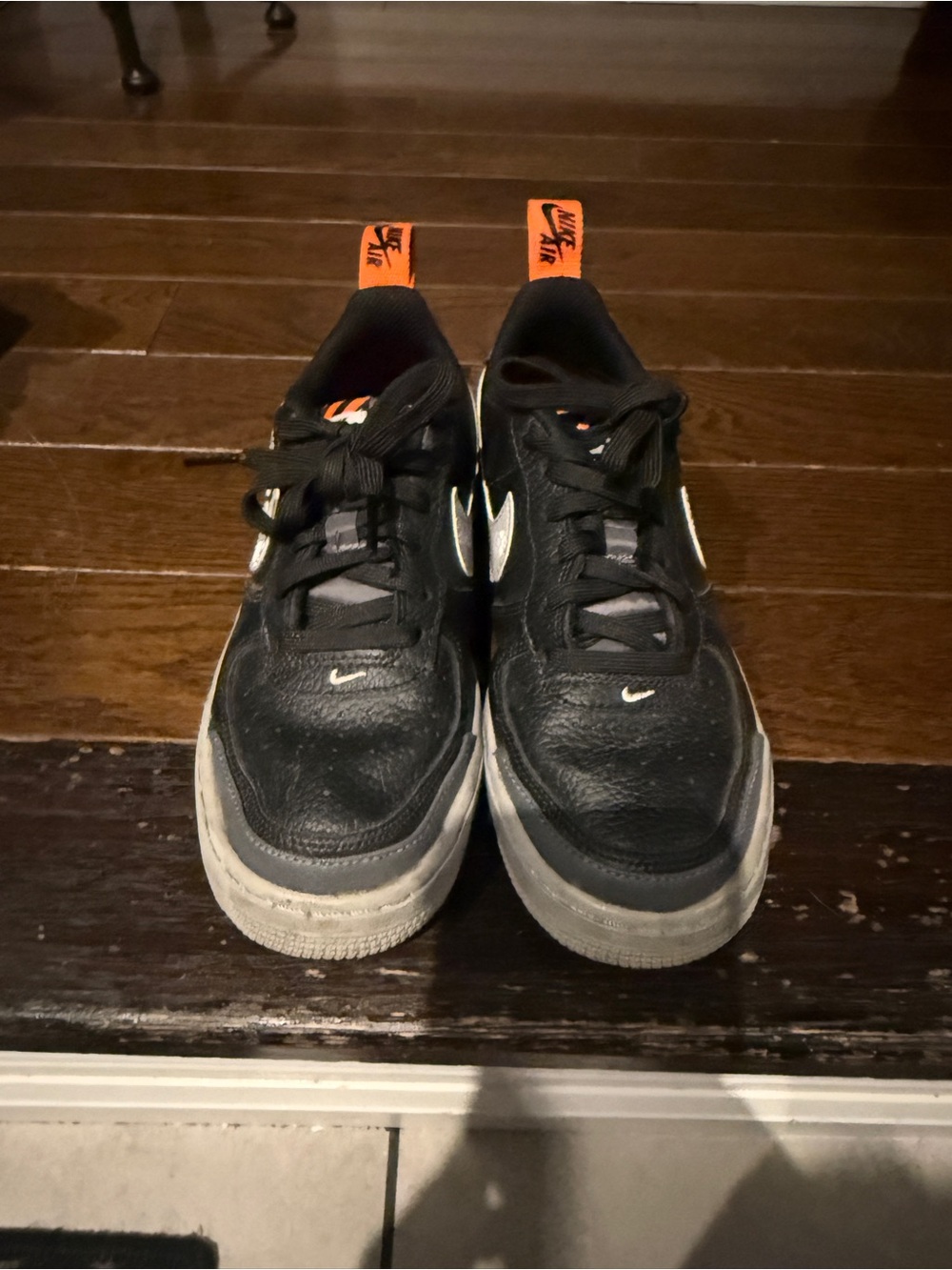 Nike Kids Black Sneakers with Orange Pull Tabs